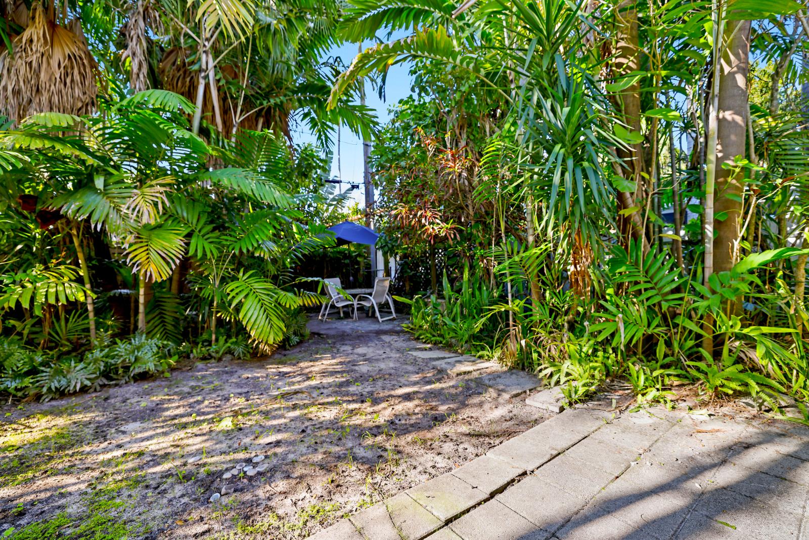 Backyard garden with fenced privacy and lush tropical landscaping