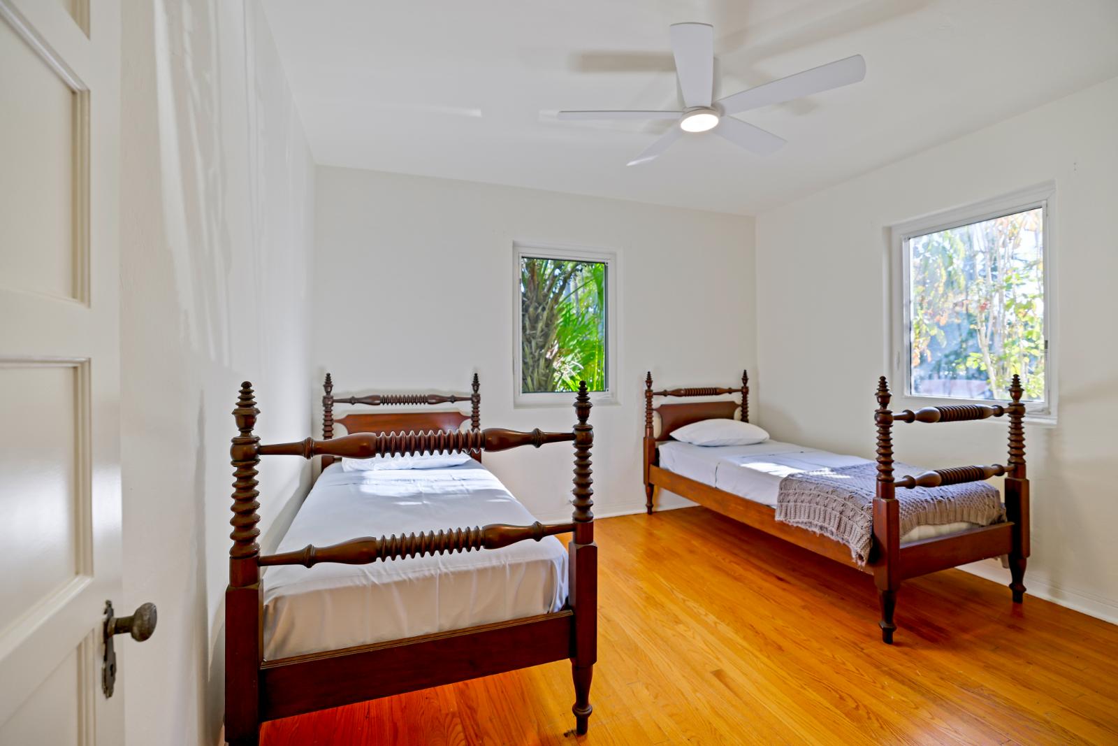 Secondary bedroom with hardwood floors and flexible sleeping layout