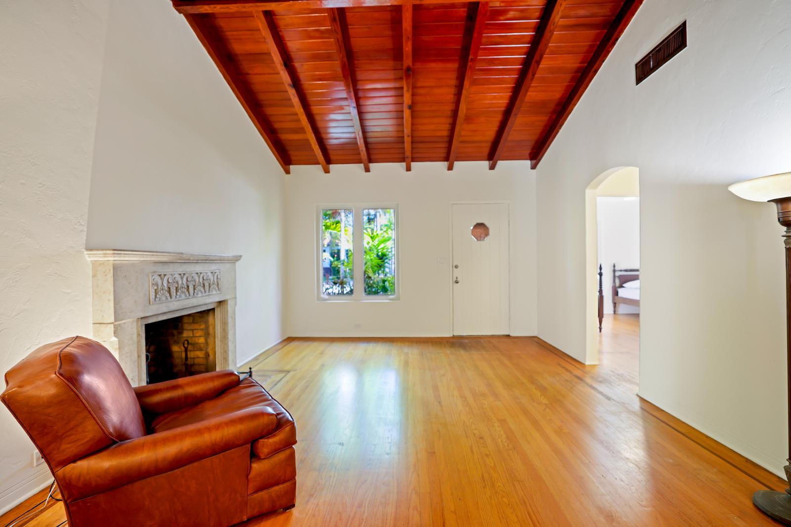 Wide living room view with fireplace and natural light