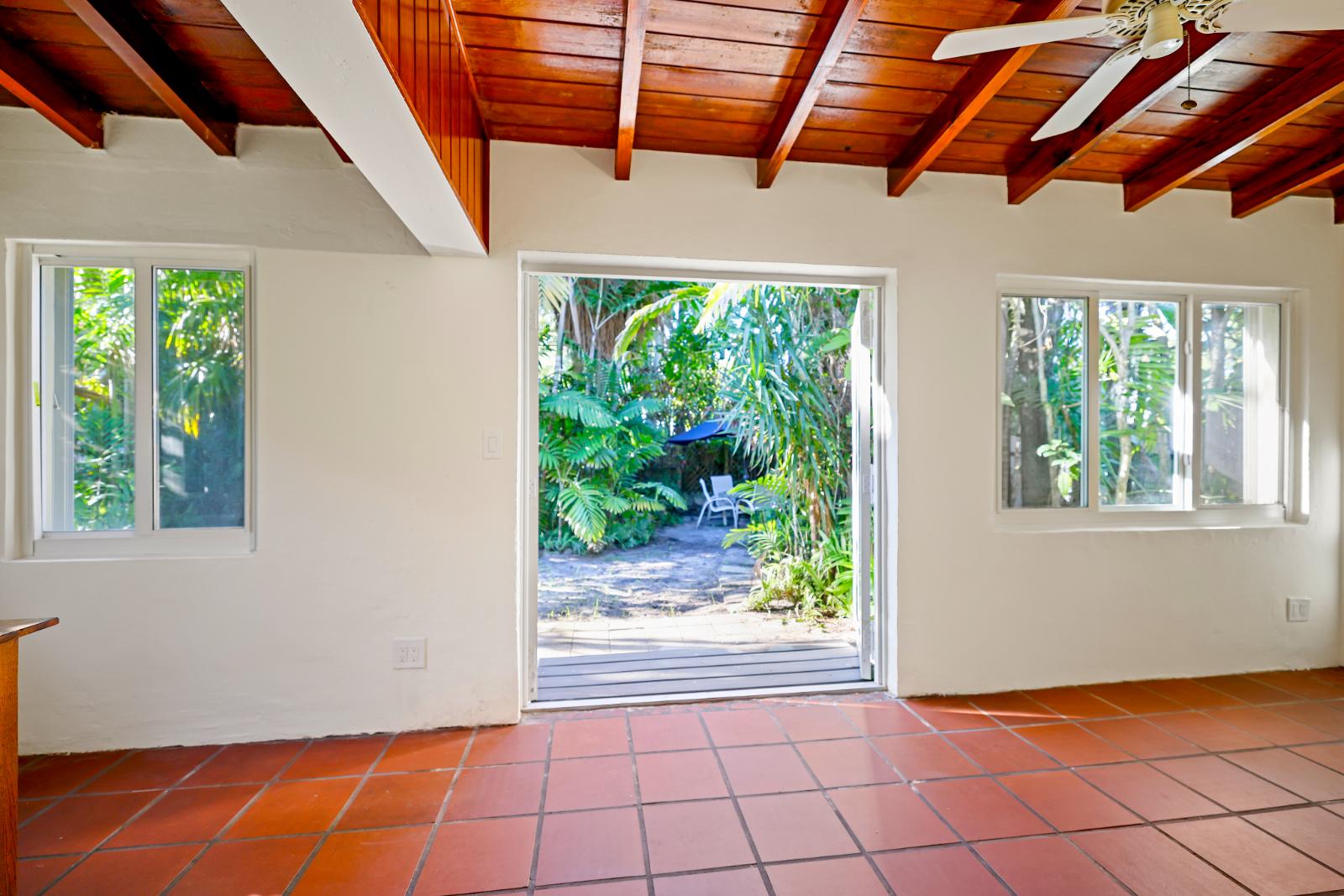 Sunroom opening toward the garden with strong indoor-outdoor connection